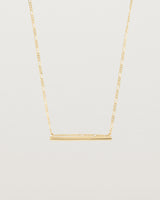 Ellipse necklace with a yellow gold bar hanging from a chain in yellow gold
