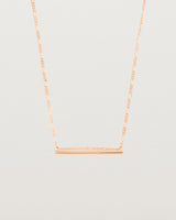 Ellipse necklace with a rose gold bar hanging from a chain in rose gold