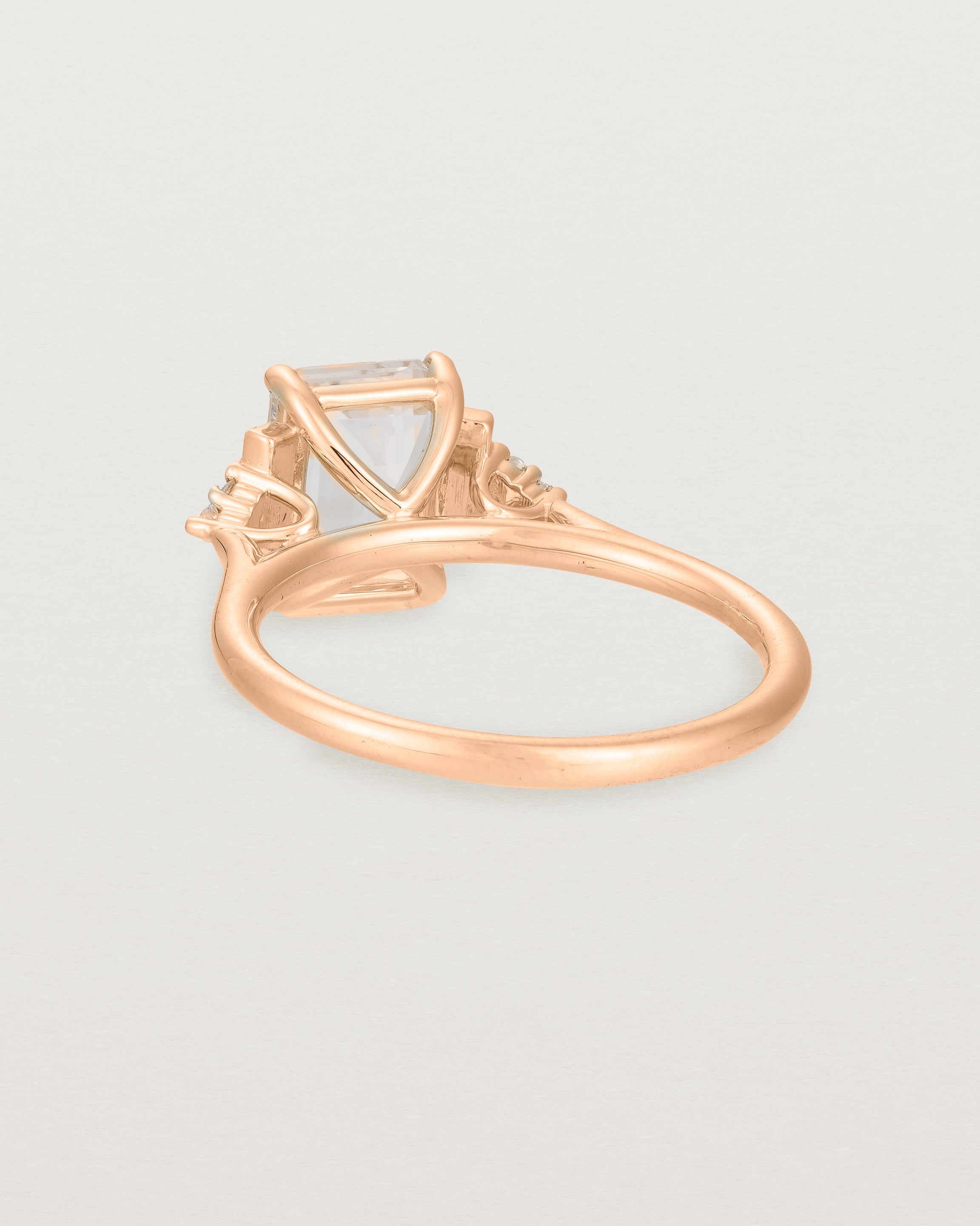 Back view of the Elodie Ring featuring a pale pink emerald cut morganite in rose gold