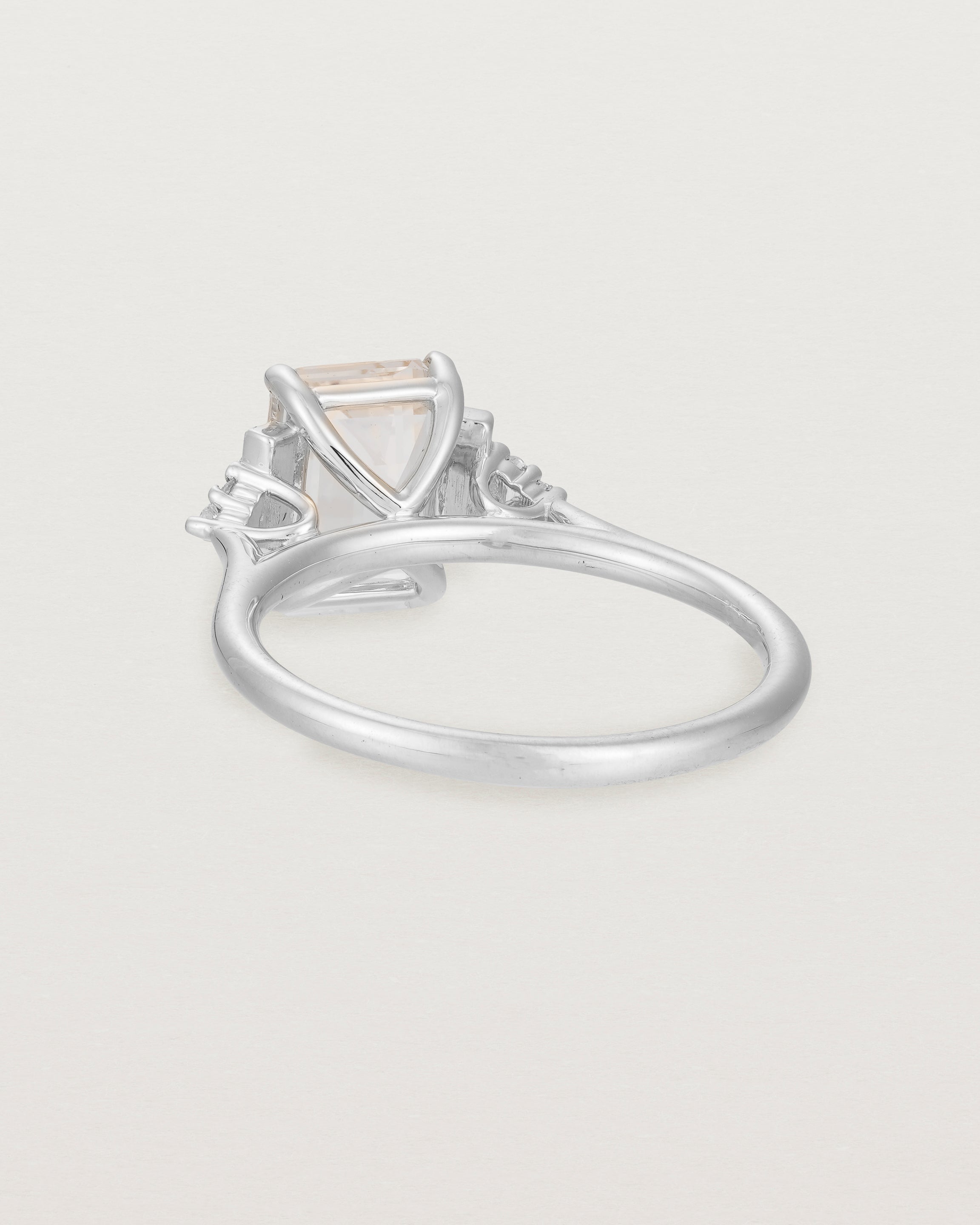 Back view of the Elodie Ring featuring a pale pink emerald cut morganite in white gold