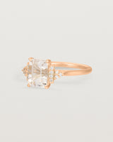Side view of the Elodie Ring featuring a pale pink emerald cut morganite in rose gold