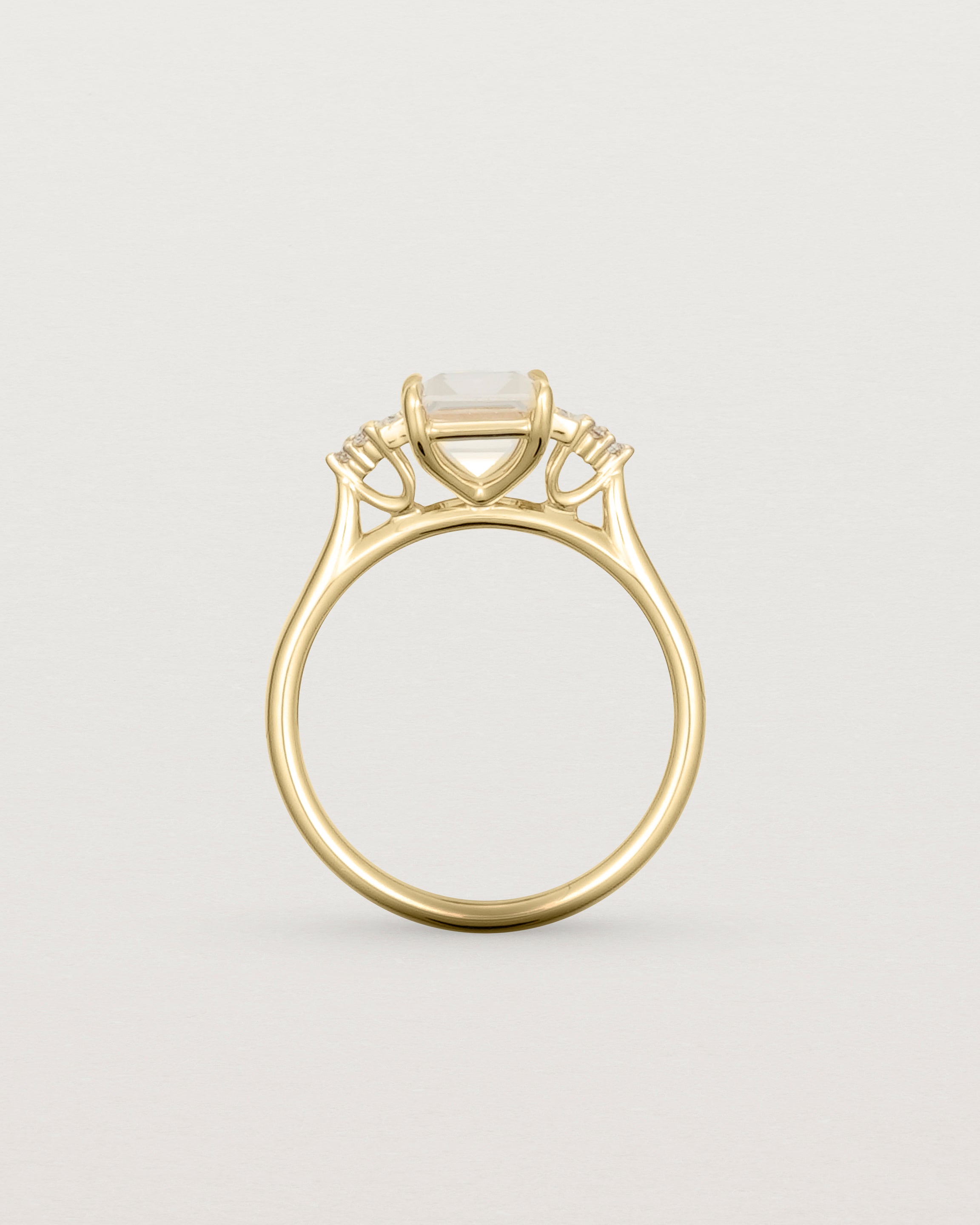 Standing view of the Elodie Ring featuring a pale pink emerald cut morganite in yellow gold