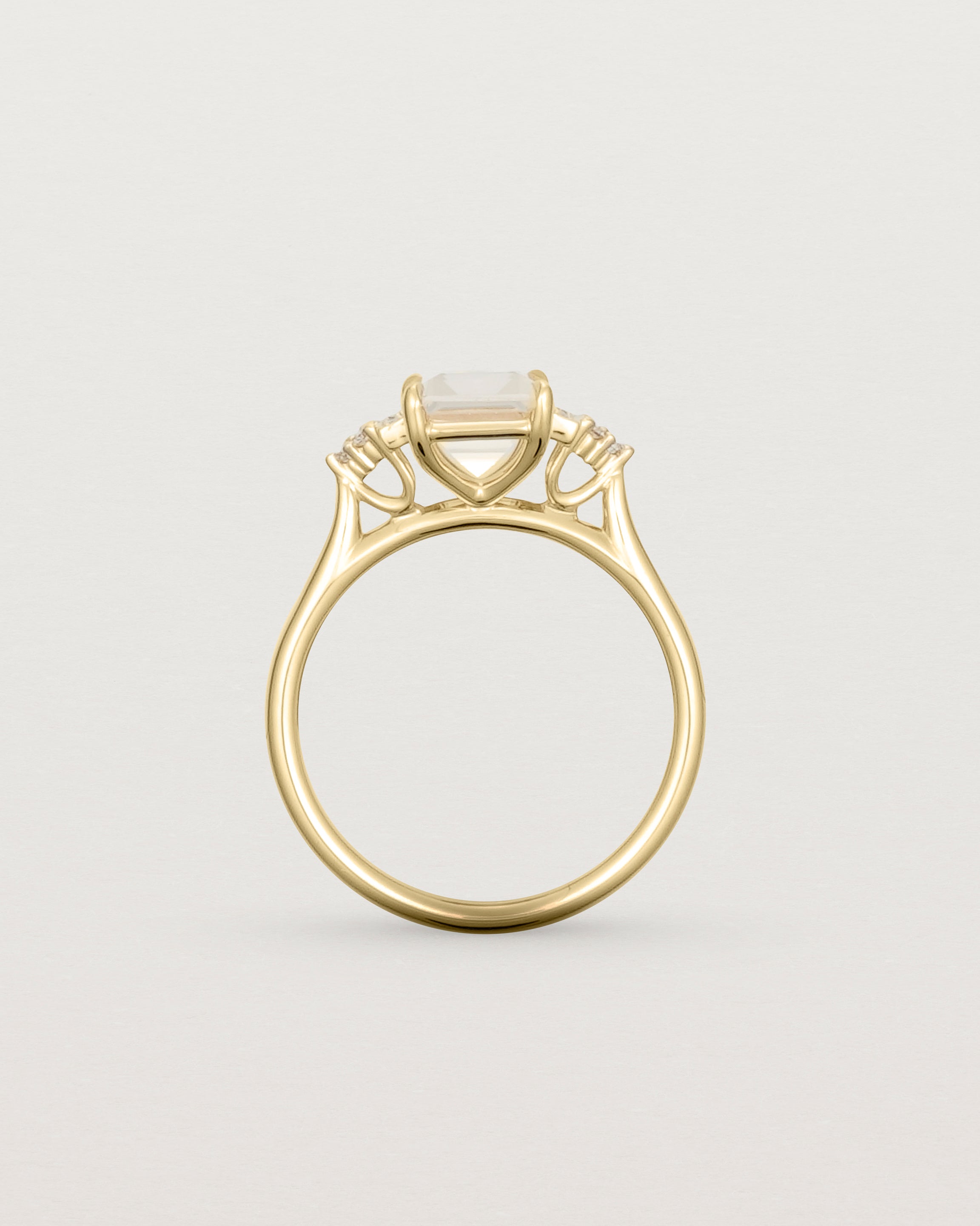 Standing view of the Elodie Ring featuring a pale pink emerald cut morganite in yellow gold