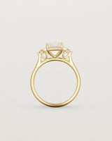 Standing view of the Elodie Ring featuring a pale pink emerald cut morganite in yellow gold