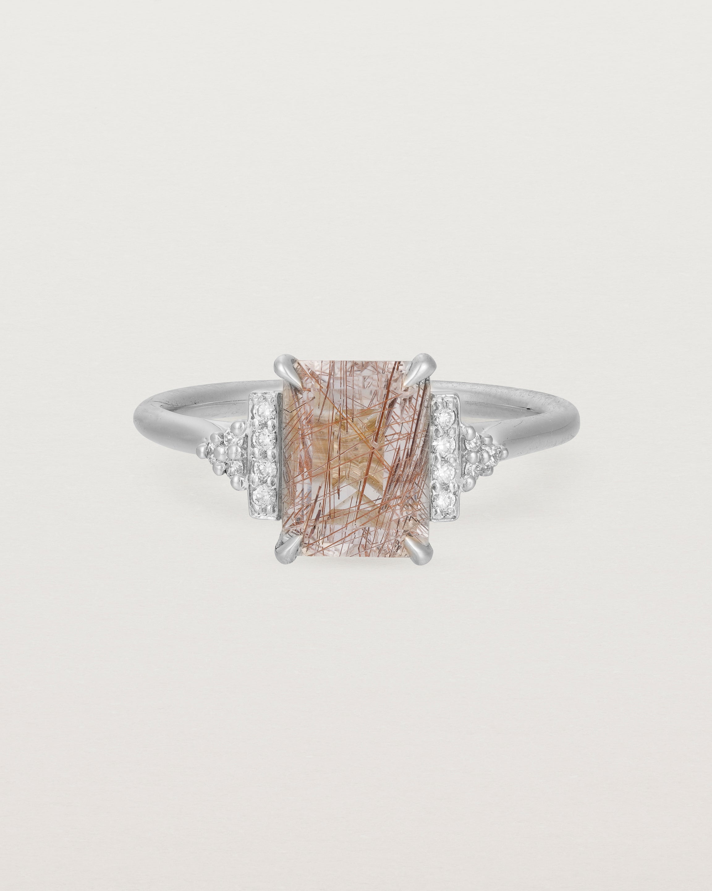 Front view of the Elodie Ring featuring a emerald cut rutilated quartz in white gold