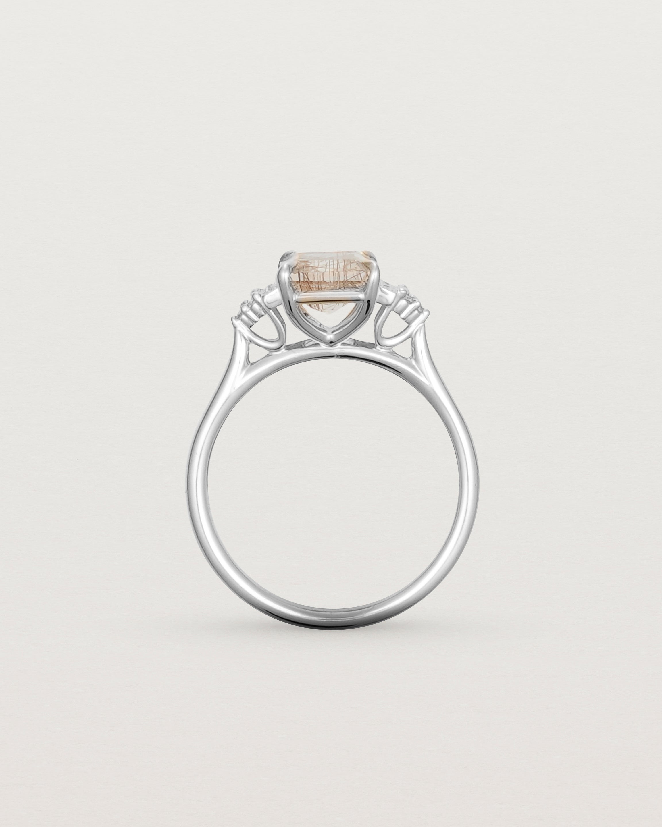Standing view of the Elodie Ring featuring a emerald cut rutilated quartz in white gold