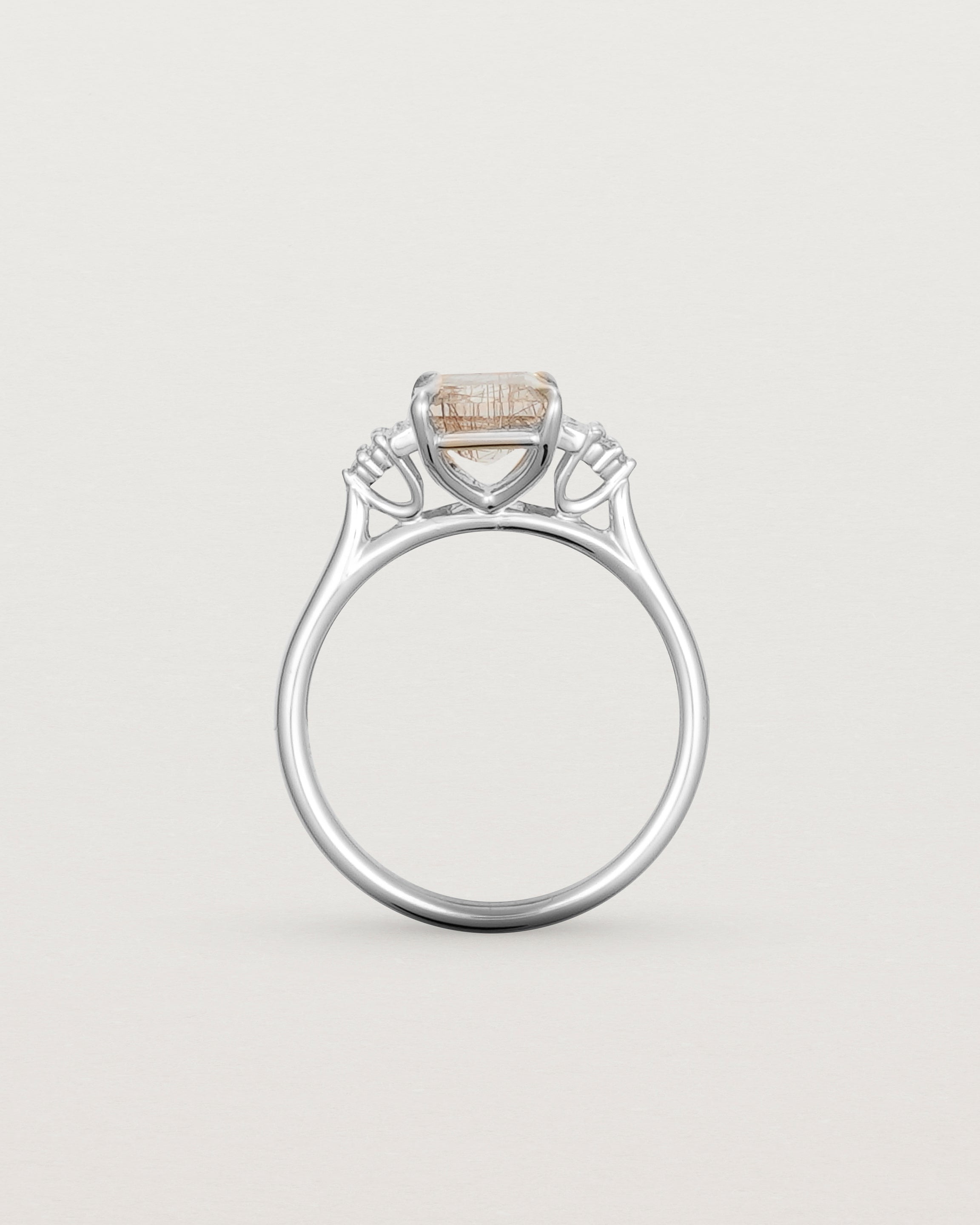Standing view of the Elodie Ring featuring a emerald cut rutilated quartz in white gold