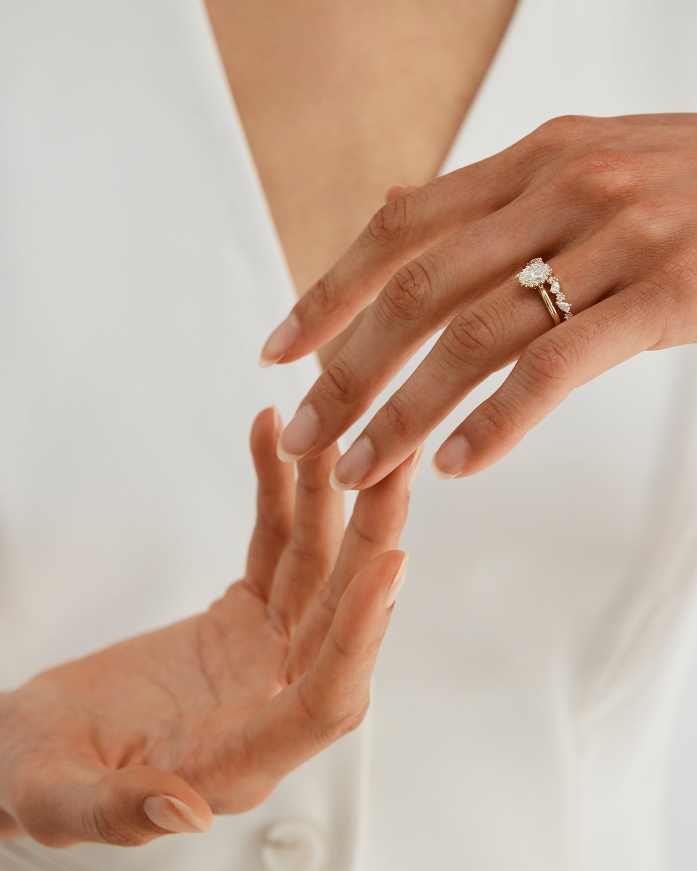 A woman wearing the Elora Ring in Diamonds stacked