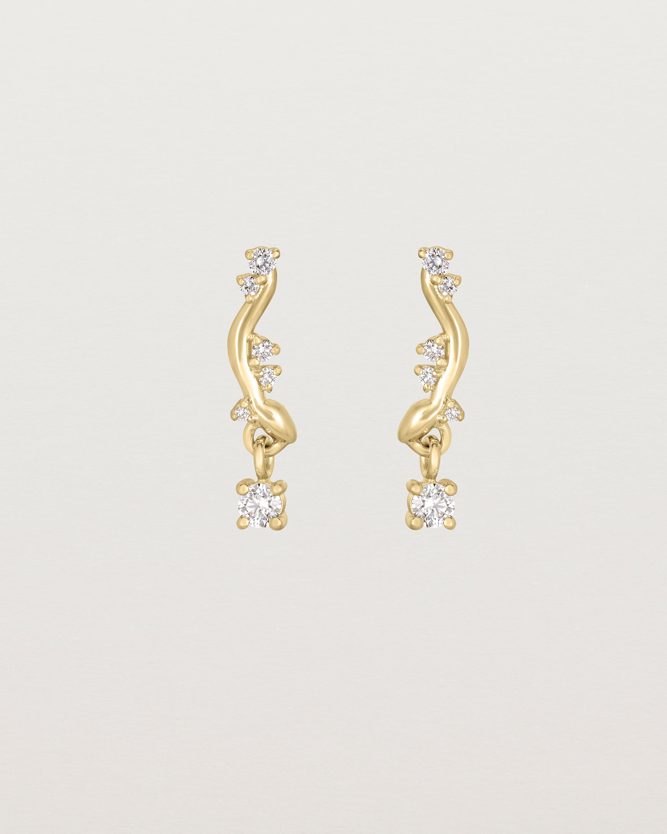 front image of diamond drop ember earrings in yellow gold.