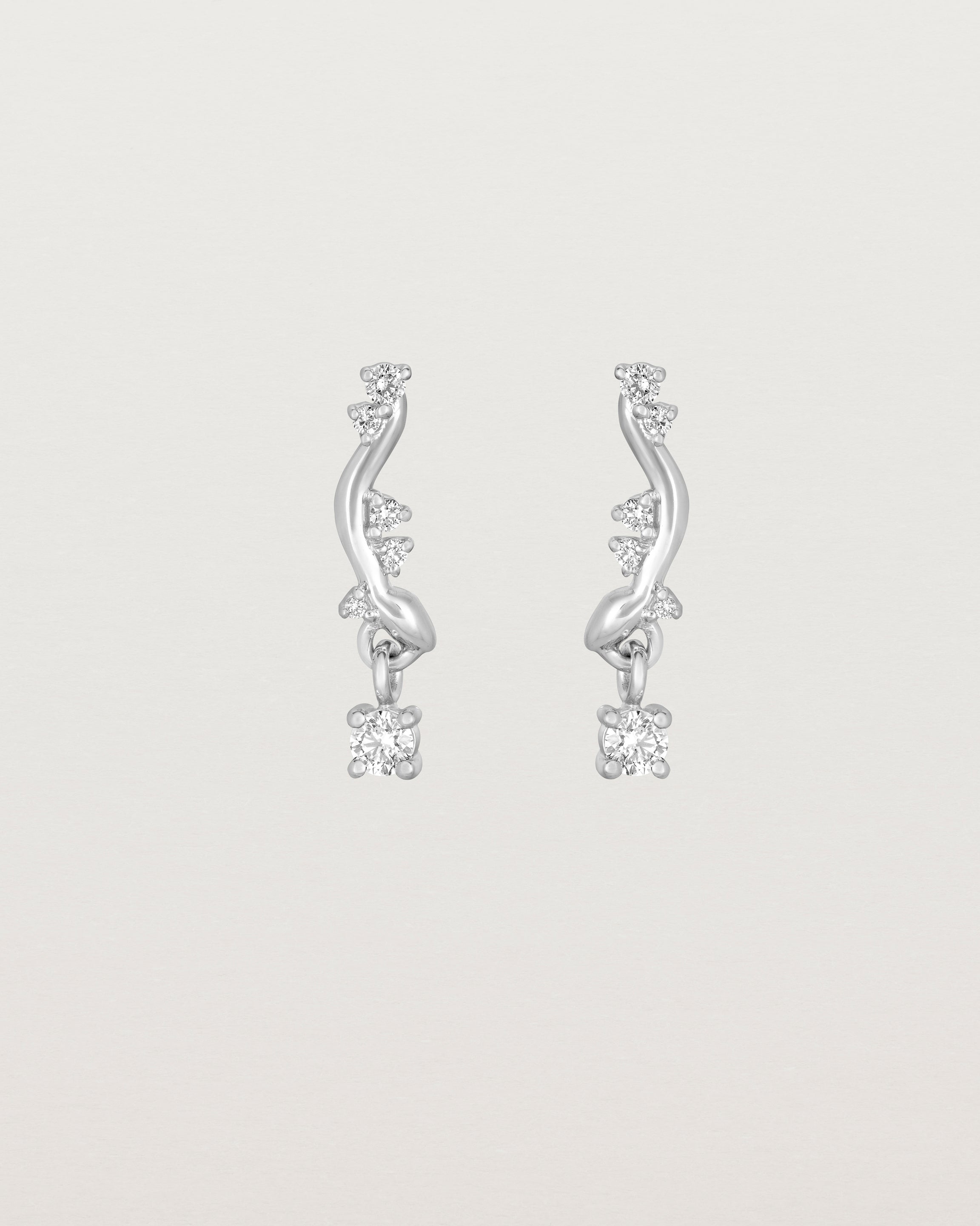 front image of diamond drop ember earrings in white gold.