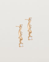 side image of diamond drop ember earrings in rose gold.