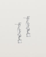 side image of diamond drop ember earrings in white gold.