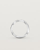 Standing image - Product photo of the white gold Ember ring with white diamonds scattered around the band.