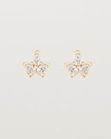 A pair of rose gold studs featuring three pear shaped diamonds