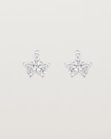 A pair of white gold studs featuring three pear shaped diamonds