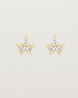 A pair of yellow gold studs featuring three pear shaped diamonds