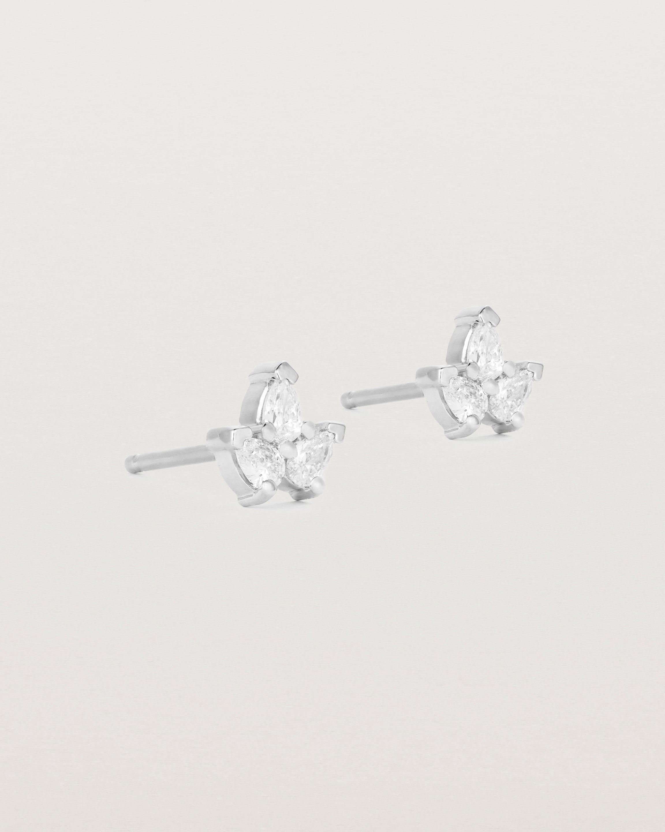 A pair of white gold studs featuring three pear shaped diamonds