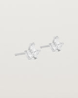 A pair of white gold studs featuring three pear shaped diamonds