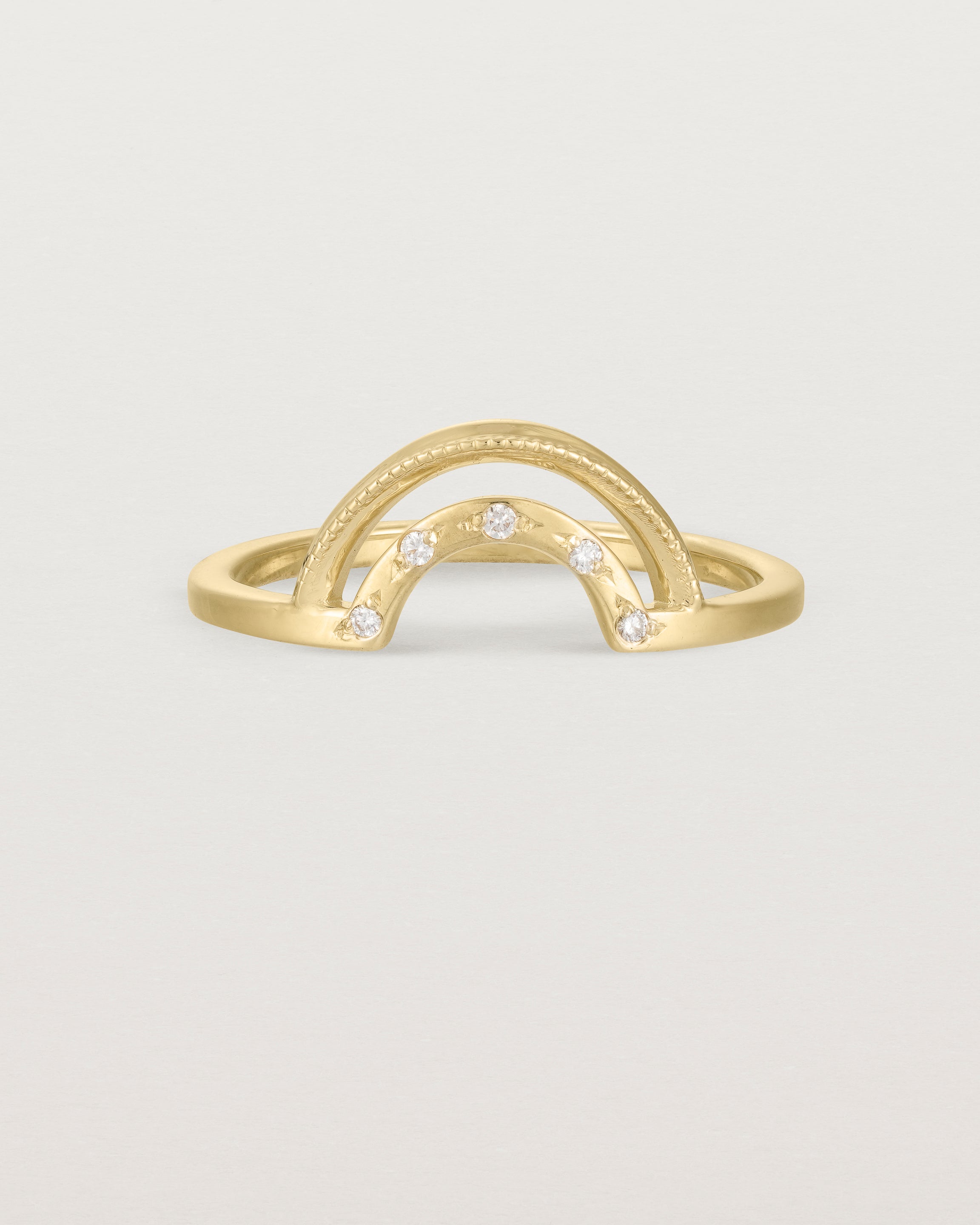 Fit two of a double arc crown ring with white diamonds adoring the inner arc - crafted in yellow gold.