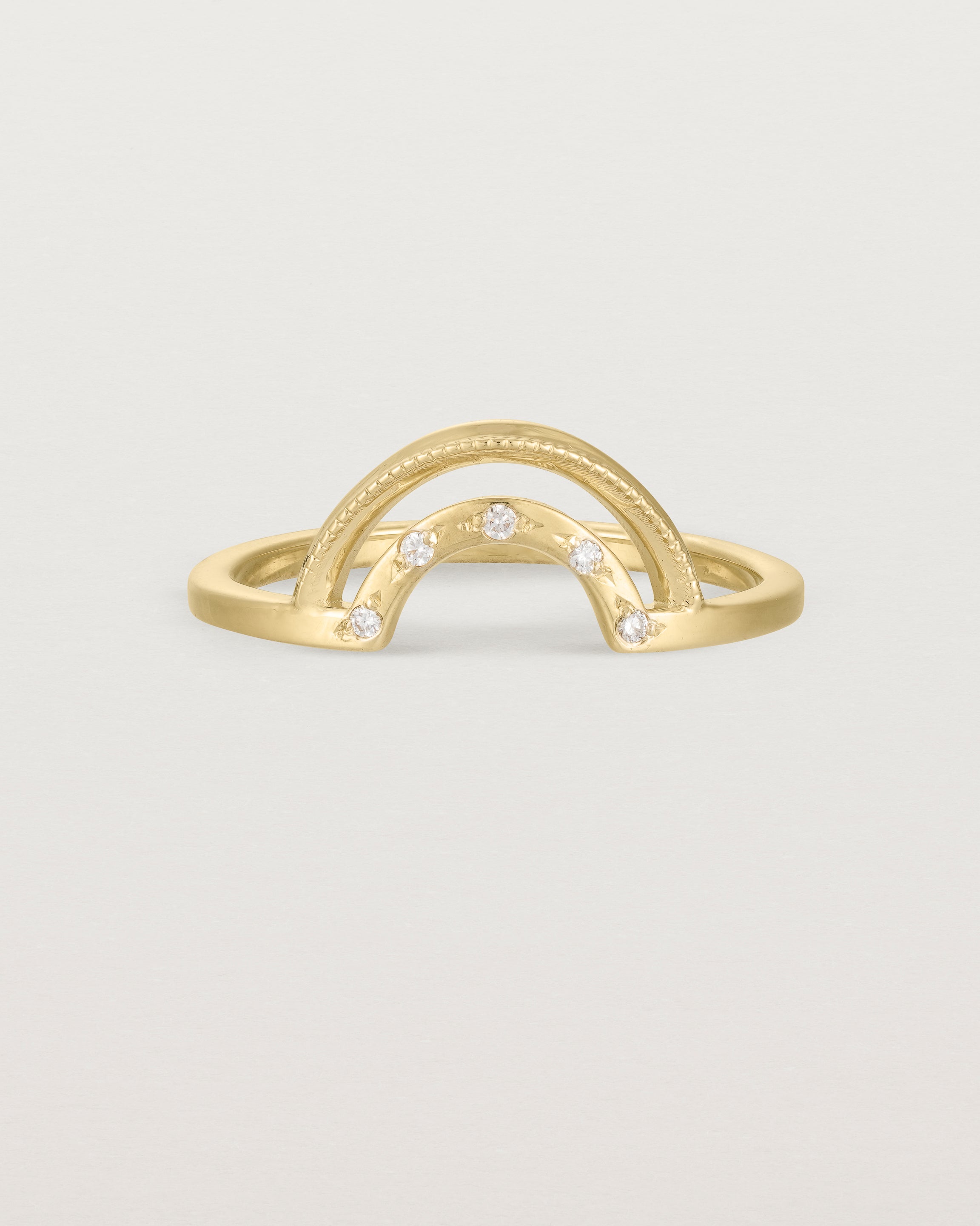 Fit two of a double arc crown ring with white diamonds adoring the inner arc - crafted in yellow gold.