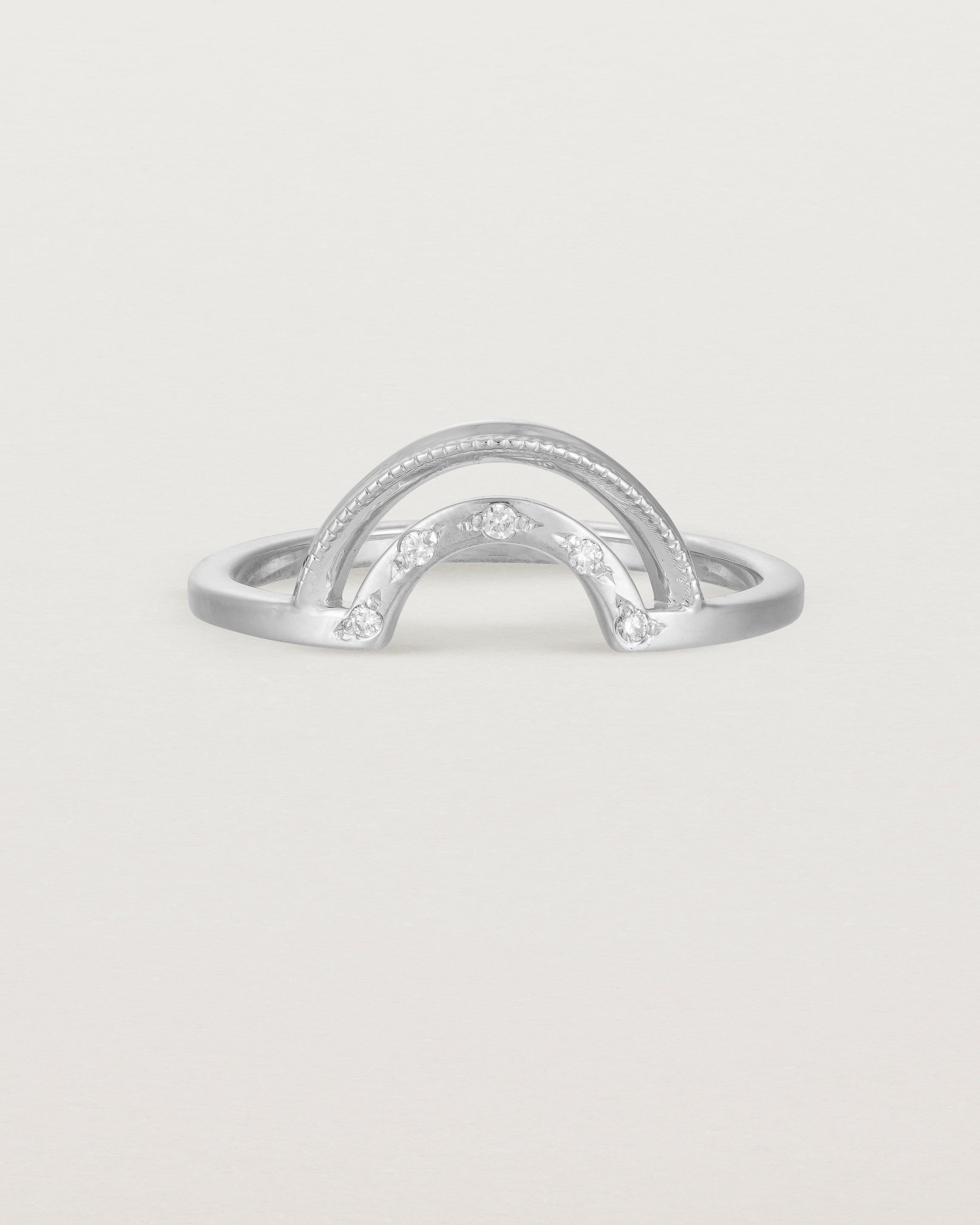 Fit two of a double arc crown ring with white diamonds adoring the inner arc - crafted in white gold.