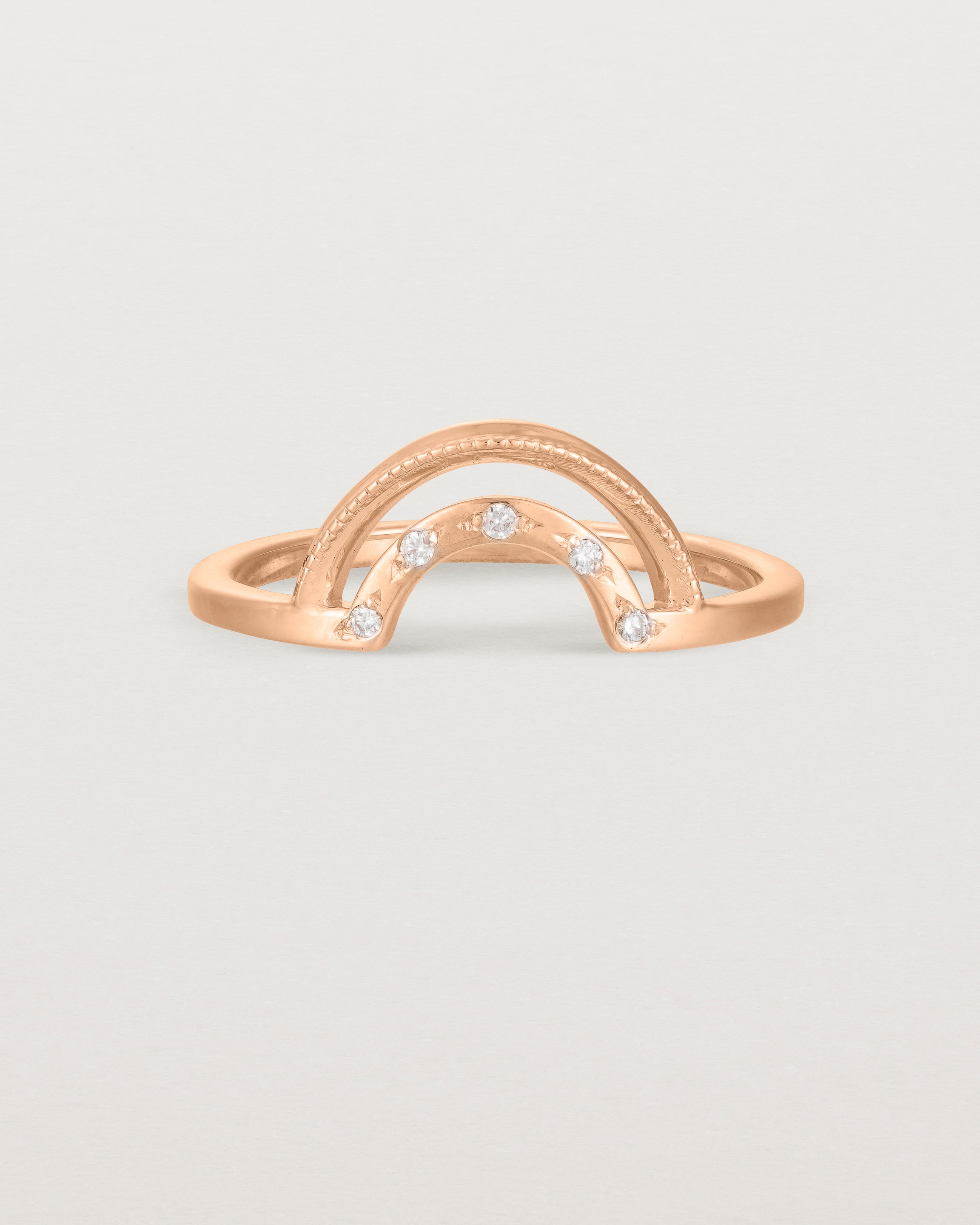 Fit two of a double arc crown ring with white diamonds adoring the inner arc - crafted in rose gold. 