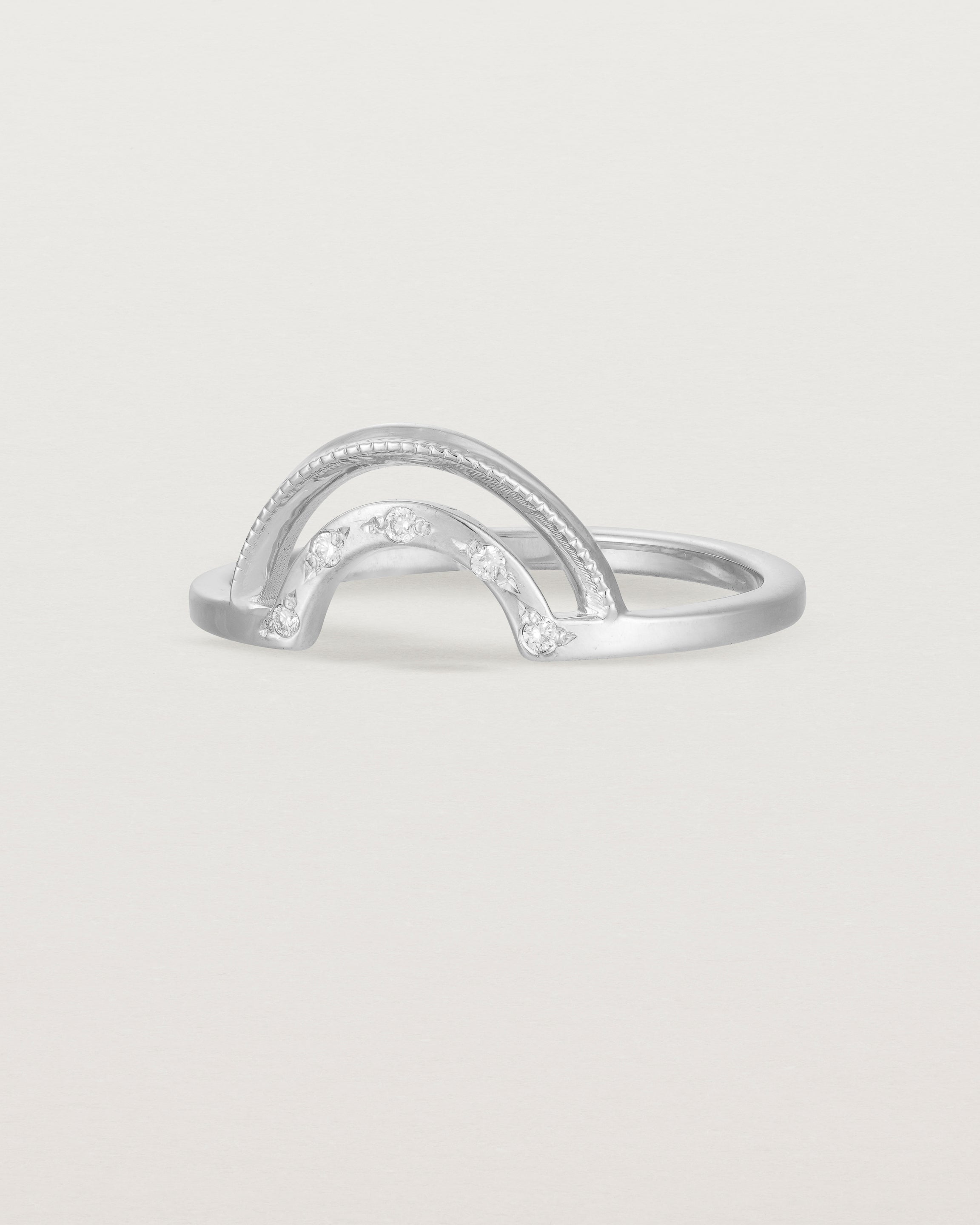 Fit two of a double arc crown ring with white diamonds adoring the inner arc - crafted in white gold.
