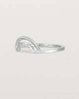 The side view of a double arc crown ring with white diamonds adoring the inner arc - crafted in white gold. 