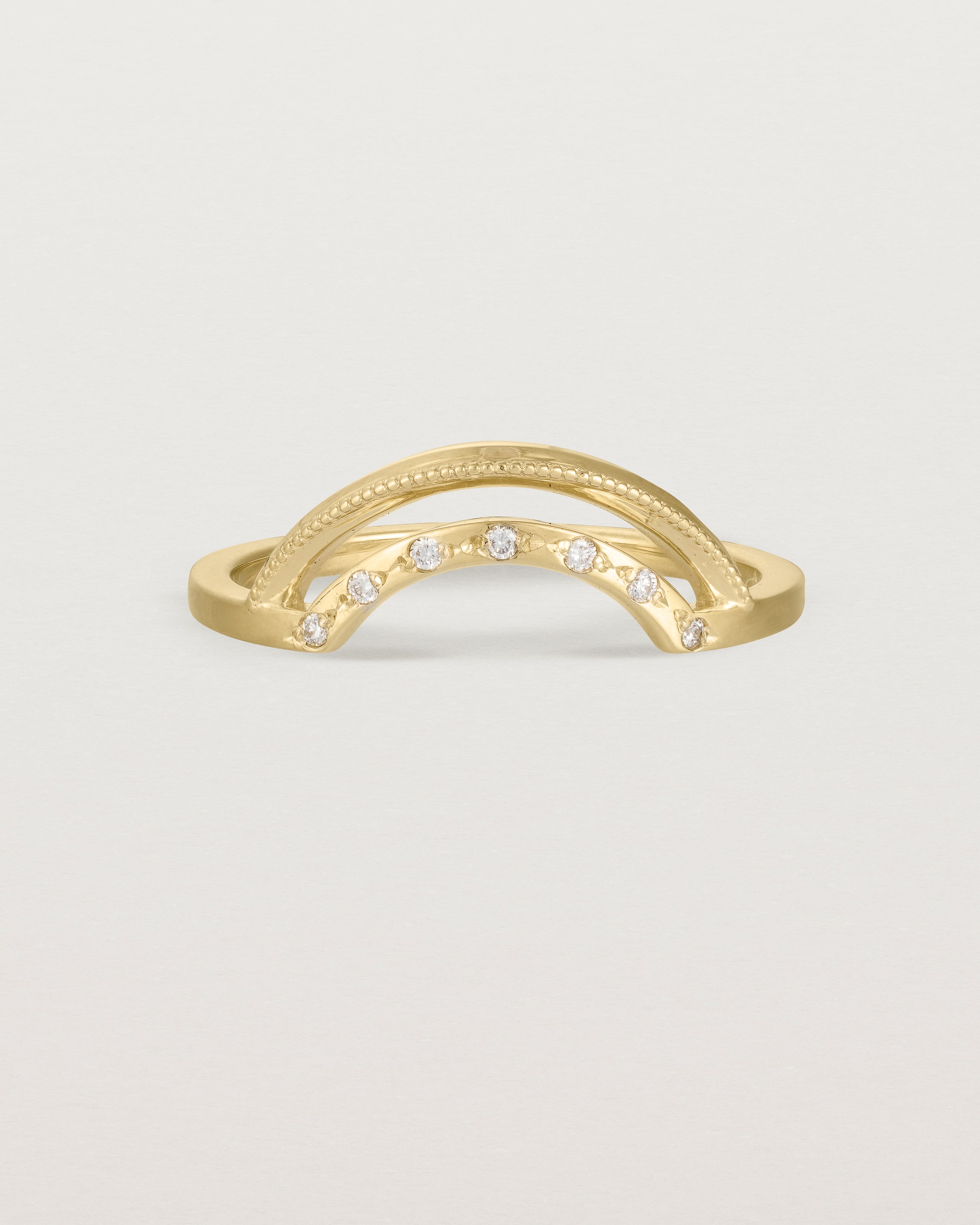 Fit four of a double arc crown ring with white diamonds adoring the inner arc - crafted in yellow gold.