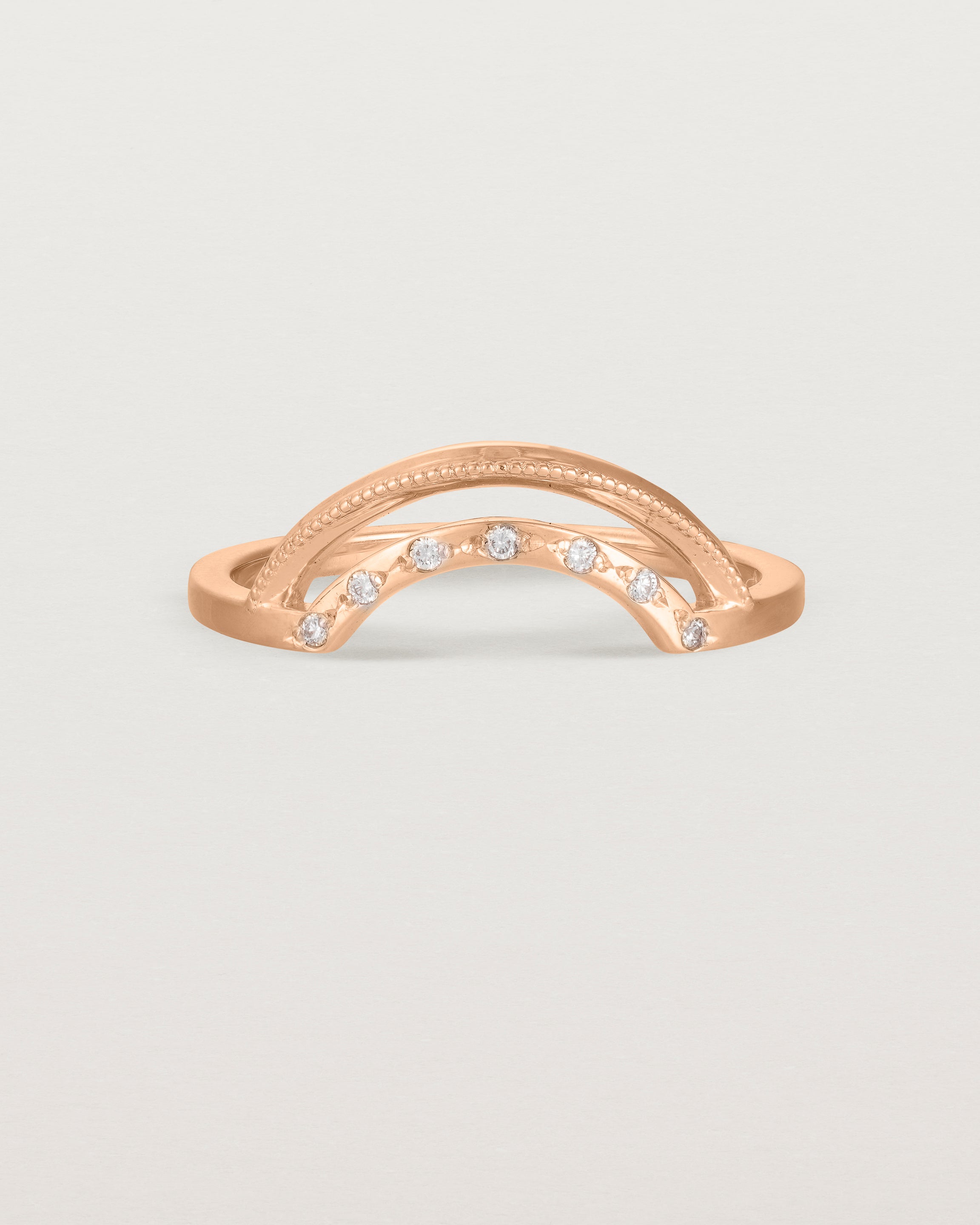 Fit four of a double arc crown ring with white diamonds adoring the inner arc - crafted in rose gold.
