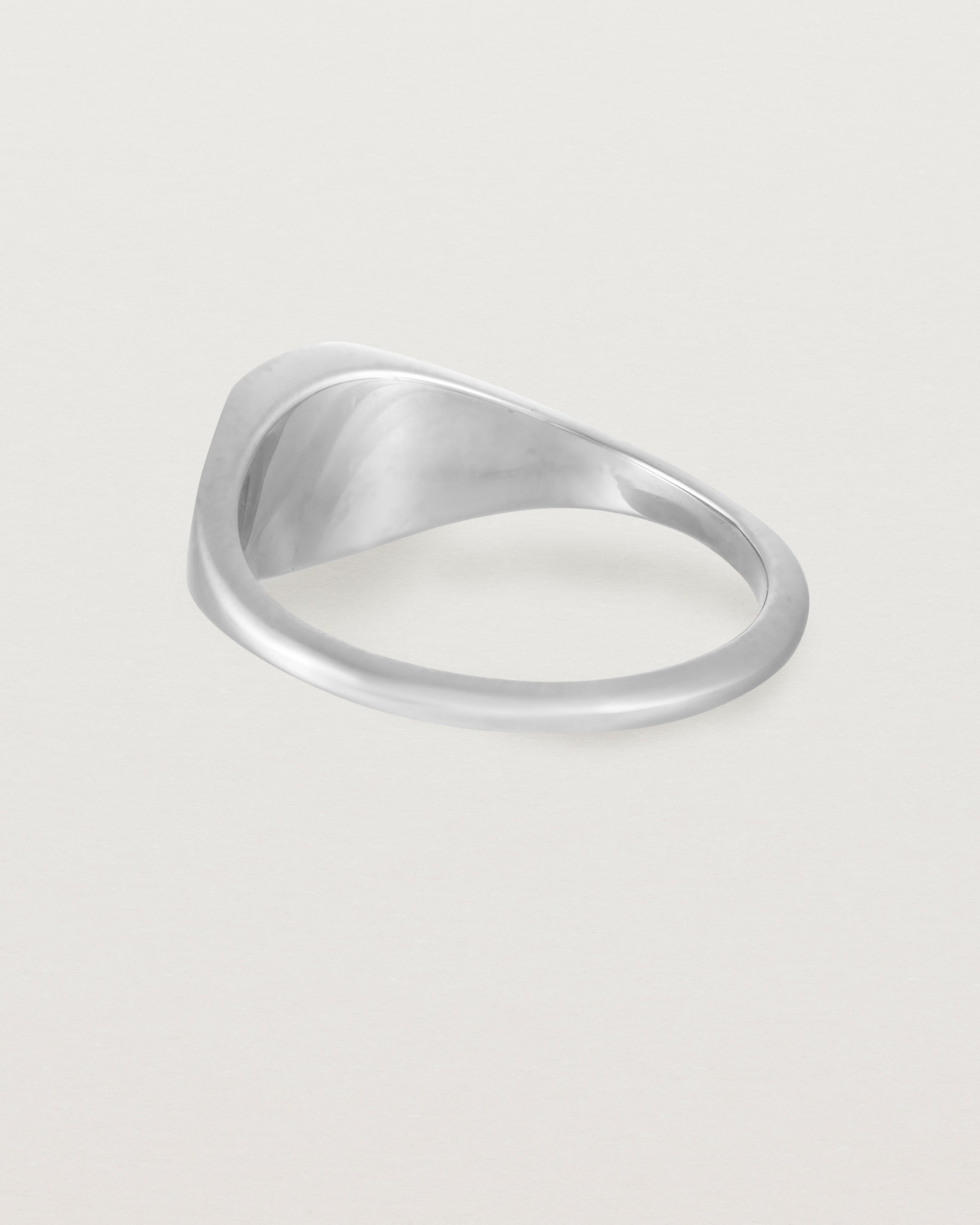 Back view of a simple signet with an elongated rectangular face in sterling silver.