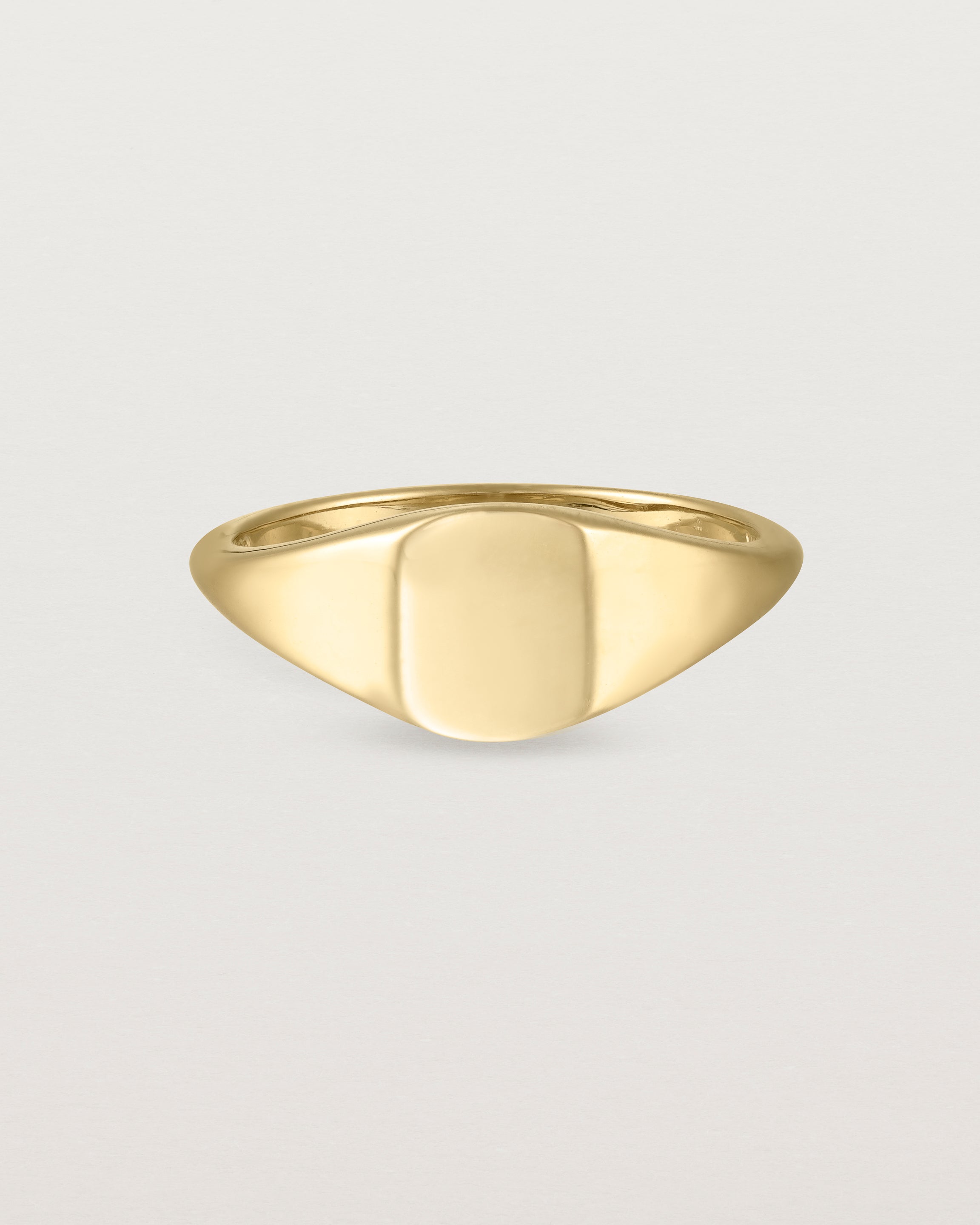 Front view of a simple signet with an elongated rectangular face in yellow gold