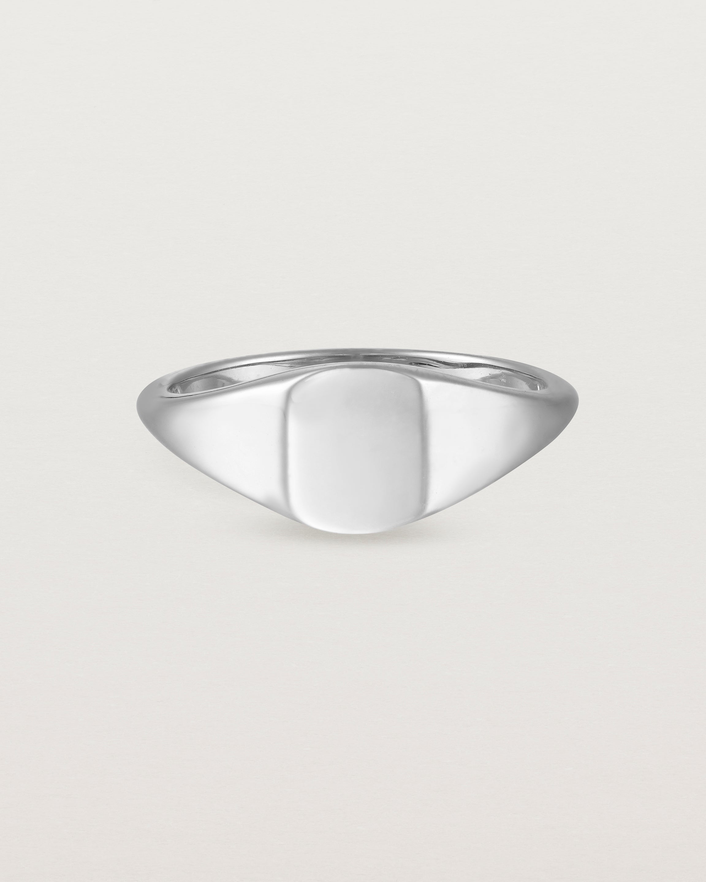 Front view of a simple signet with an elongated rectangular face in white gold