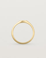 Standing view of a simple signet with an elongated rectangular face in yellow gold
