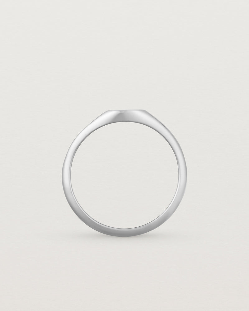 Standing view of a simple signet with an elongated rectangular face in sterling silver.