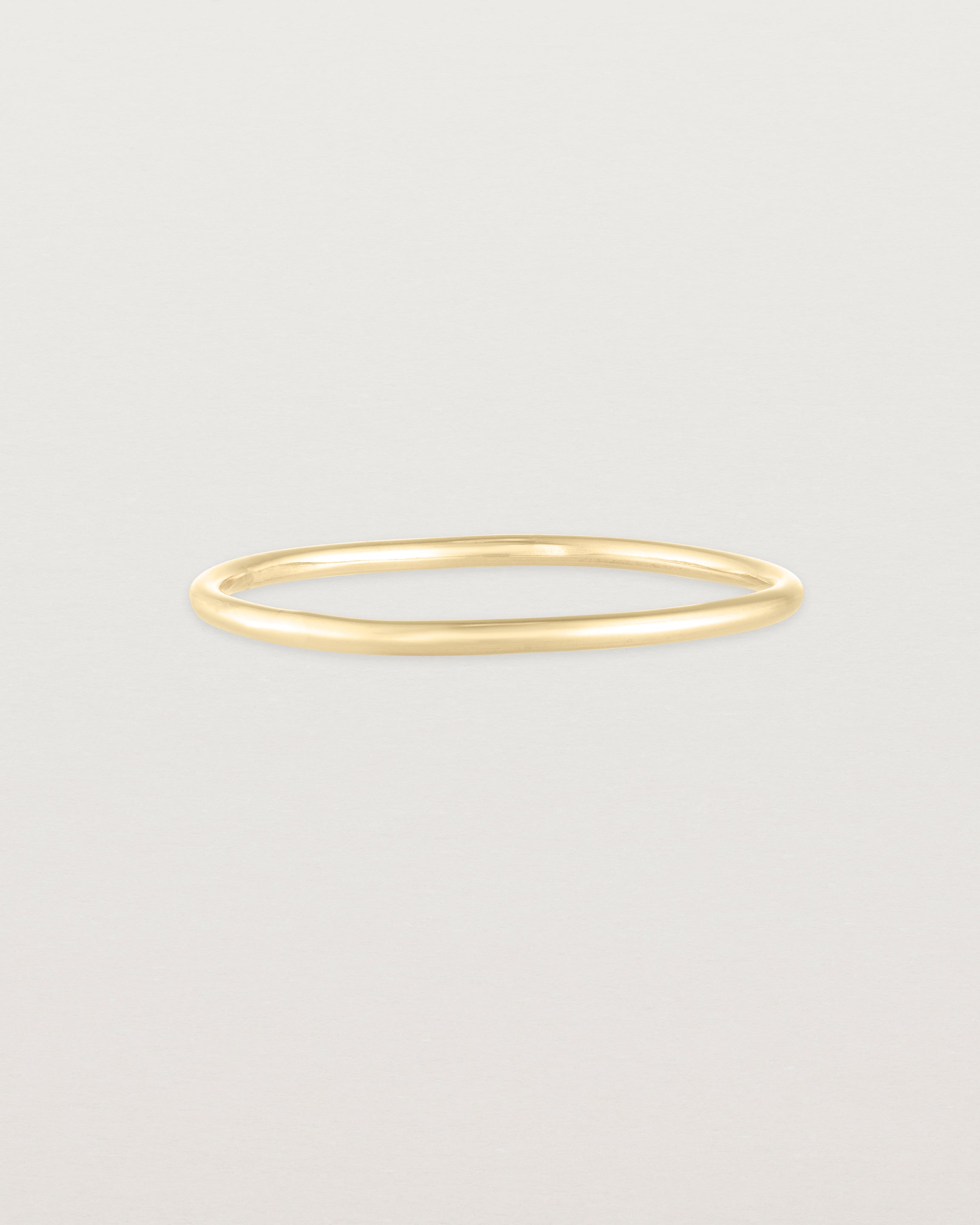 Front view of the Fine Stacking Ring in yellow gold.