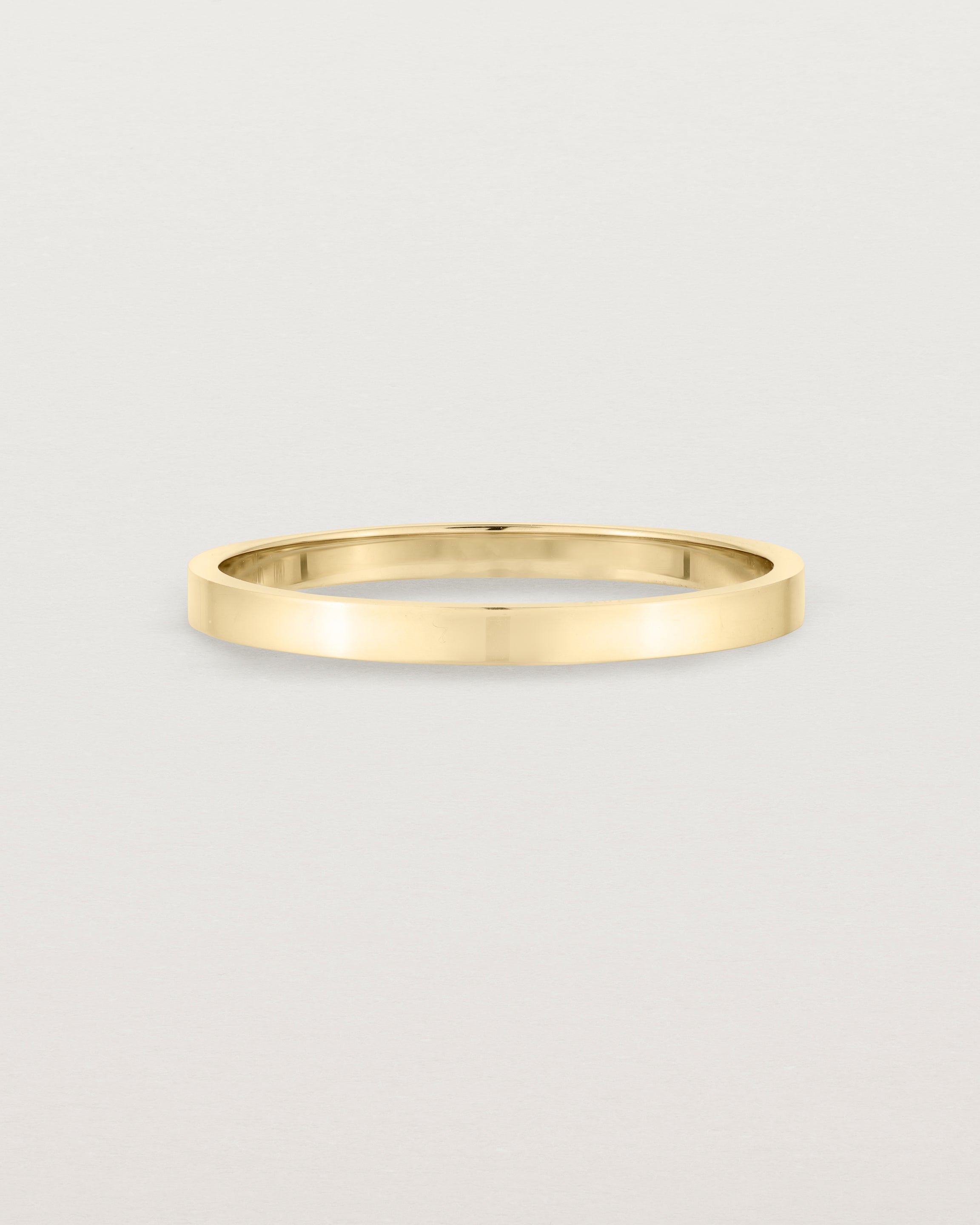 Our square profile, flat wedding band crafted in yellow gold