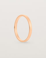The side profile of our square profile, flat wedding band crafted in rose gold