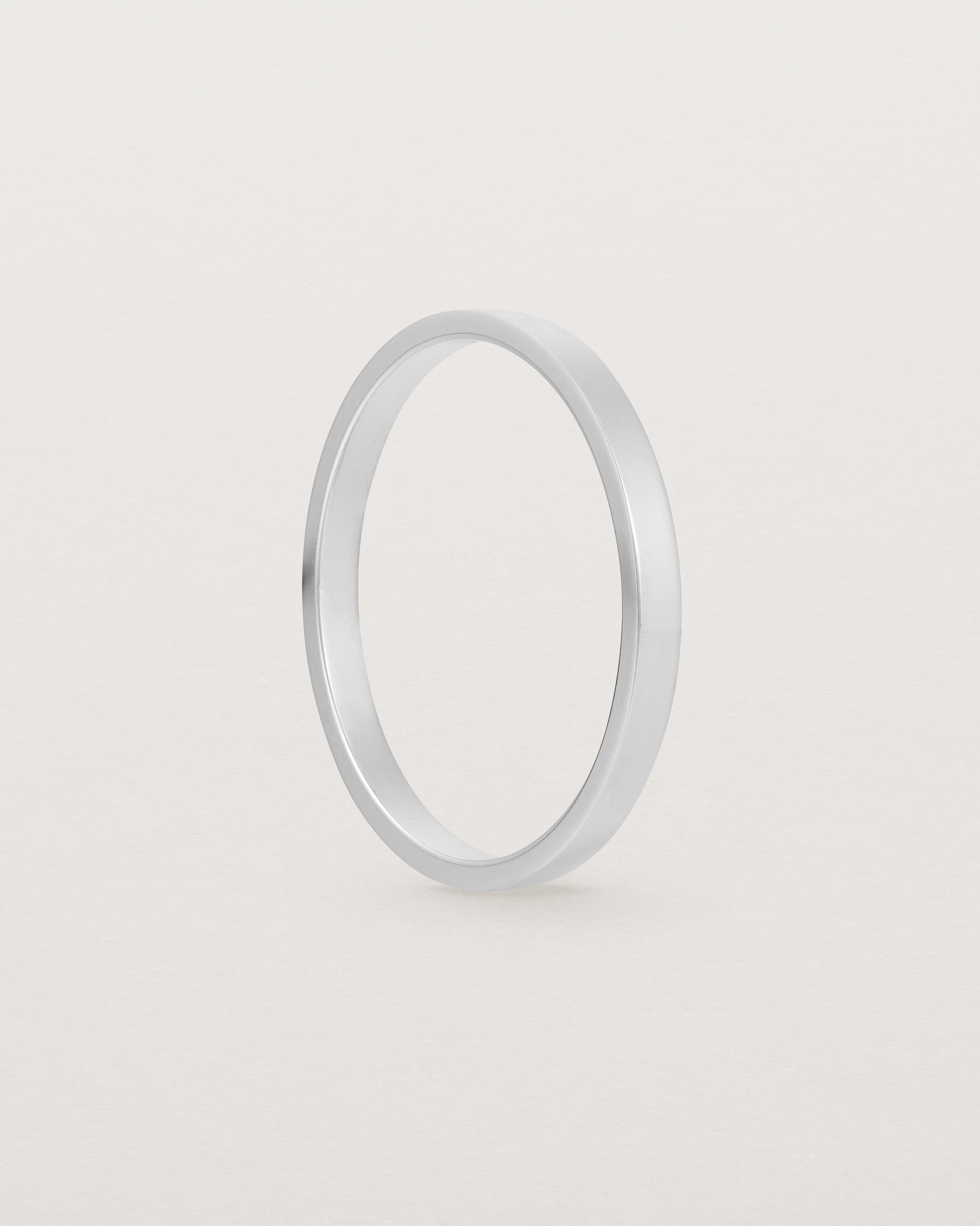 The side profile of our square profile, flat wedding band crafted in white gold