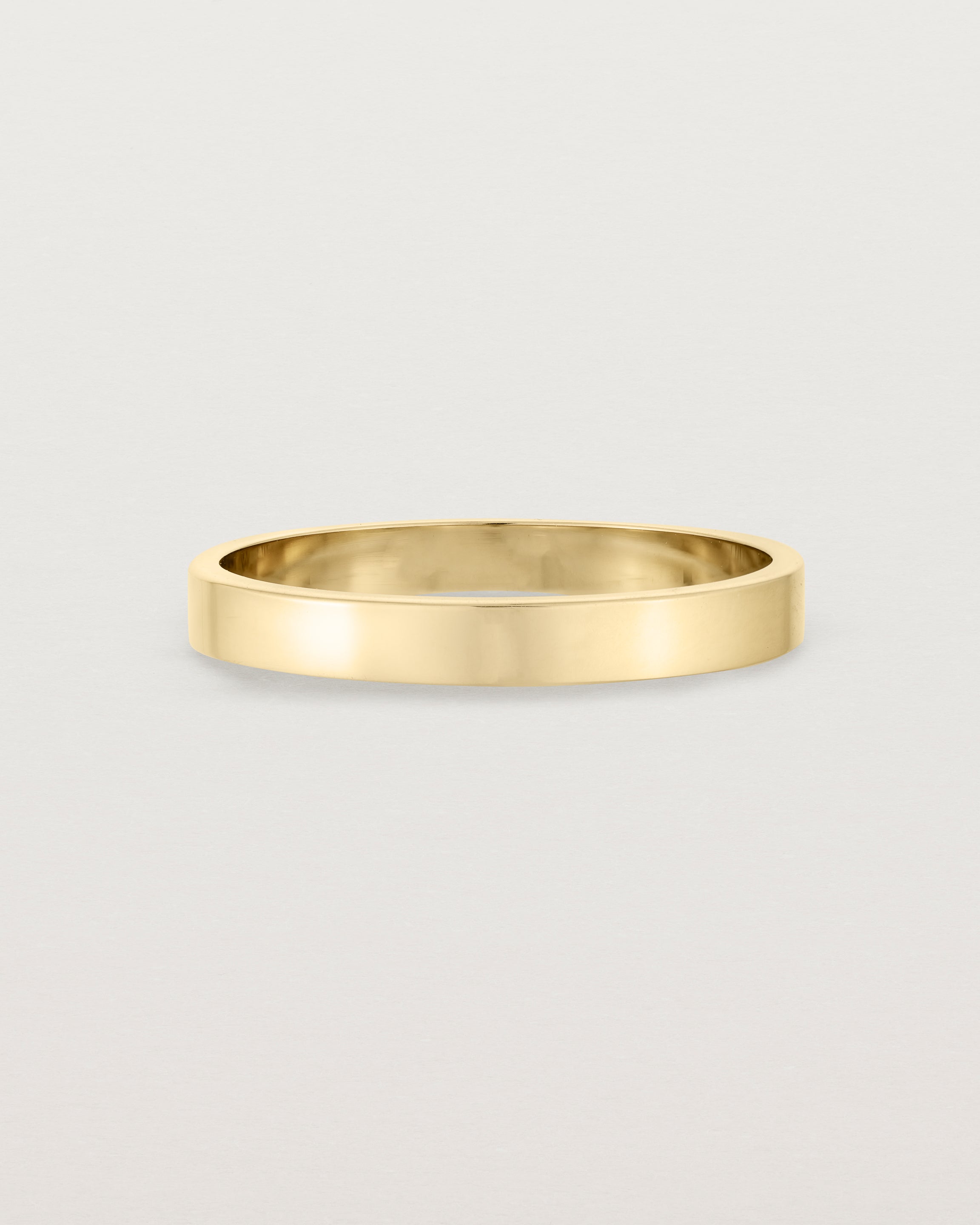 Our square, flat 3mm profile wedding band crafted in yellow gold
