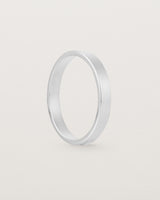 The side profile of our square, flat 3mm profile wedding band crafted in white gold