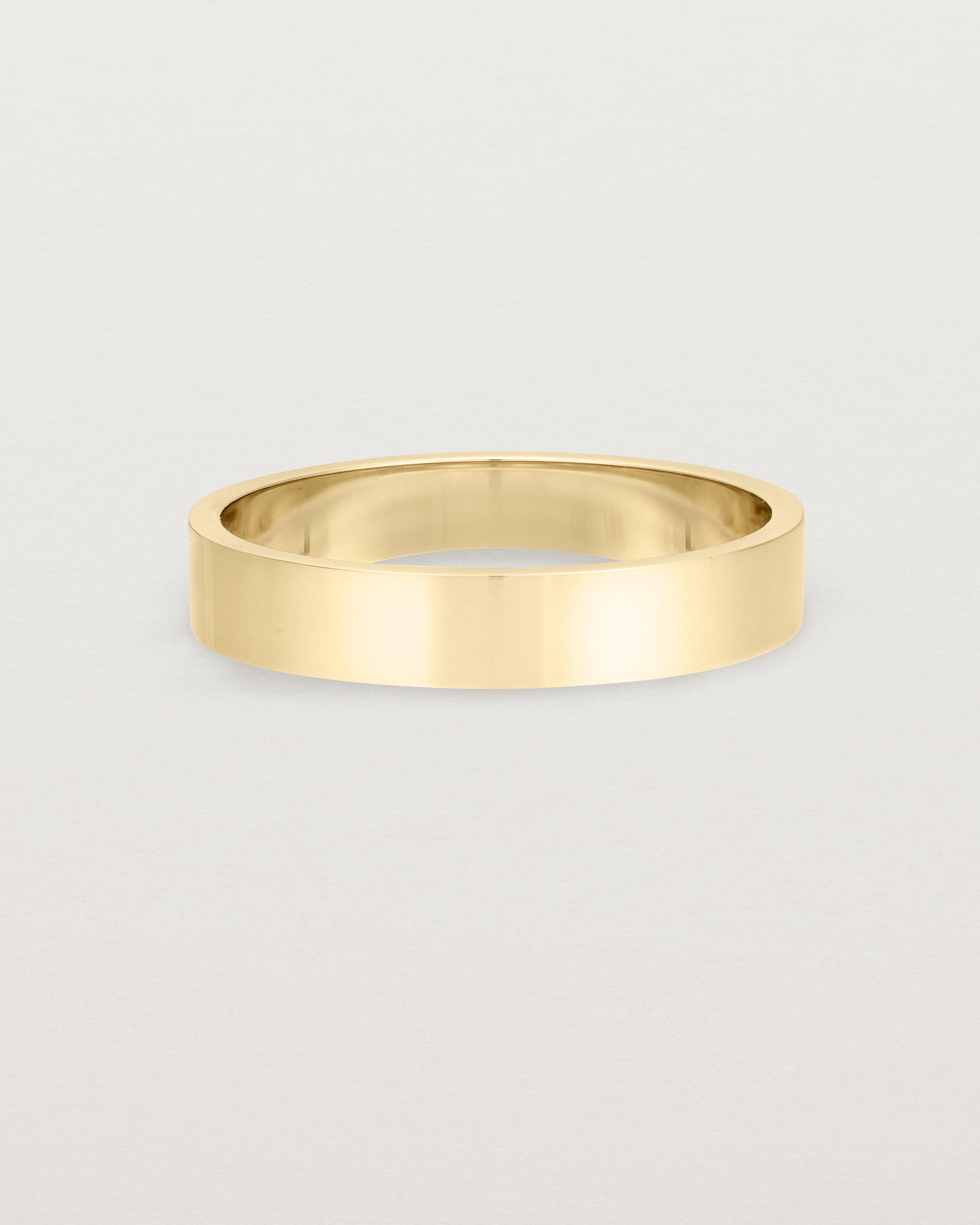 Our square, flat 4mm profile wedding band crafted in yellow gold