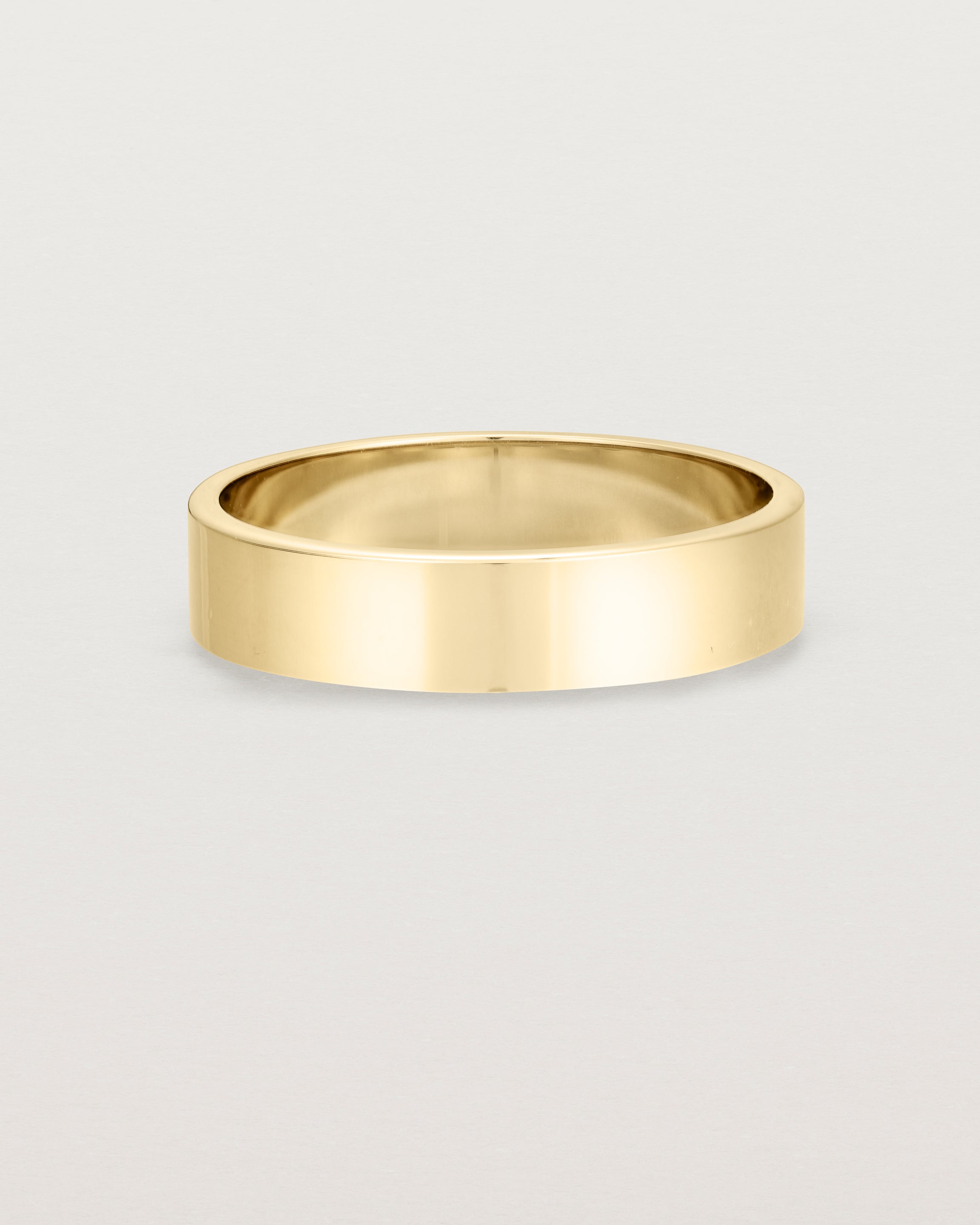 Our square profile, 5mm flat wedding band crafted in yellow gold