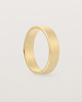 The side profile of our square profile, 5mm flat wedding band crafted in yellow gold