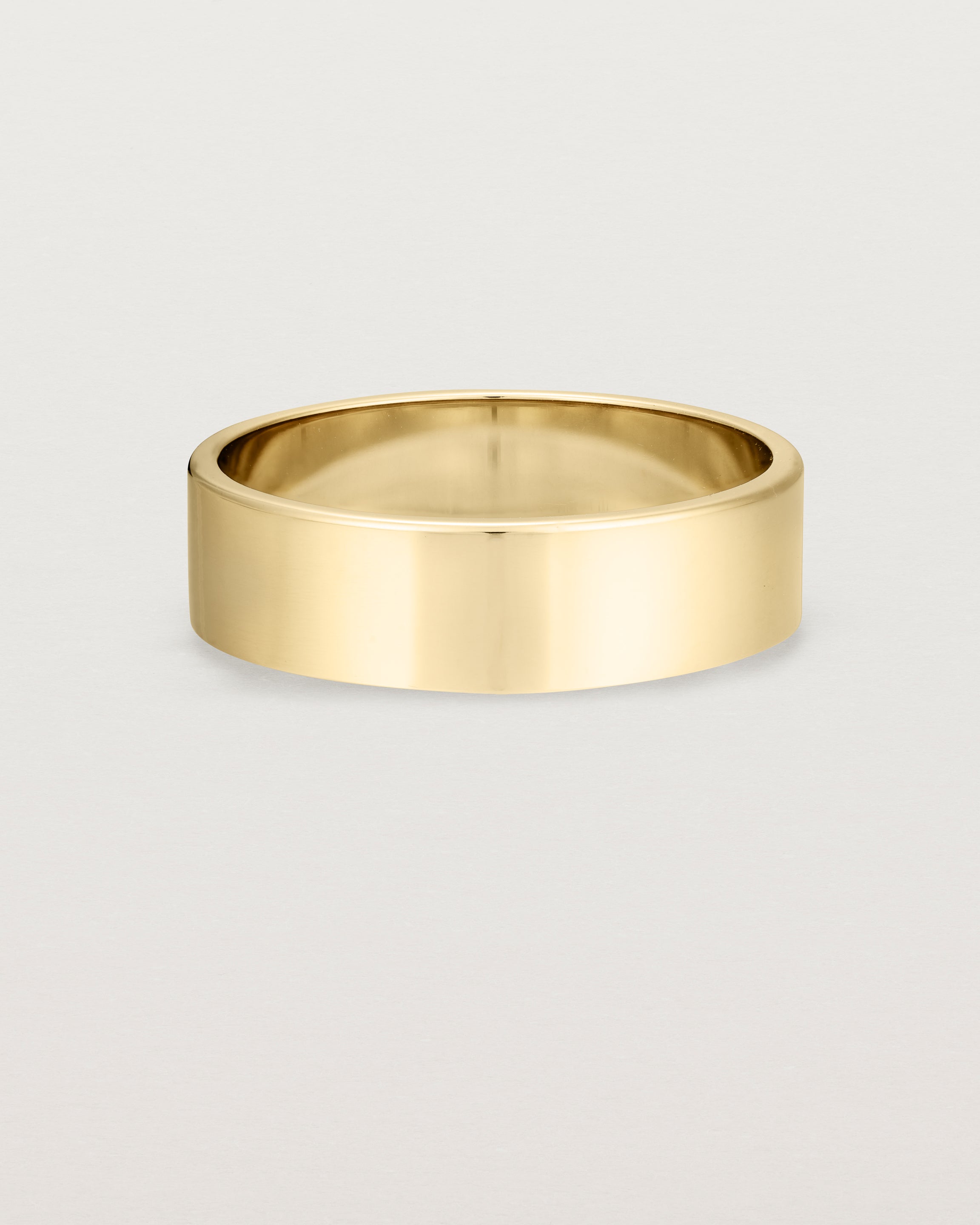 Our square profile, 6mm flat wedding band crafted in yellow gold