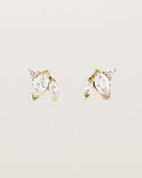 A pair of yellow gold studs featuring two marquise and one round diamond