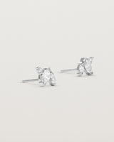 A pair of white gold studs featuring two marquise and one round diamond