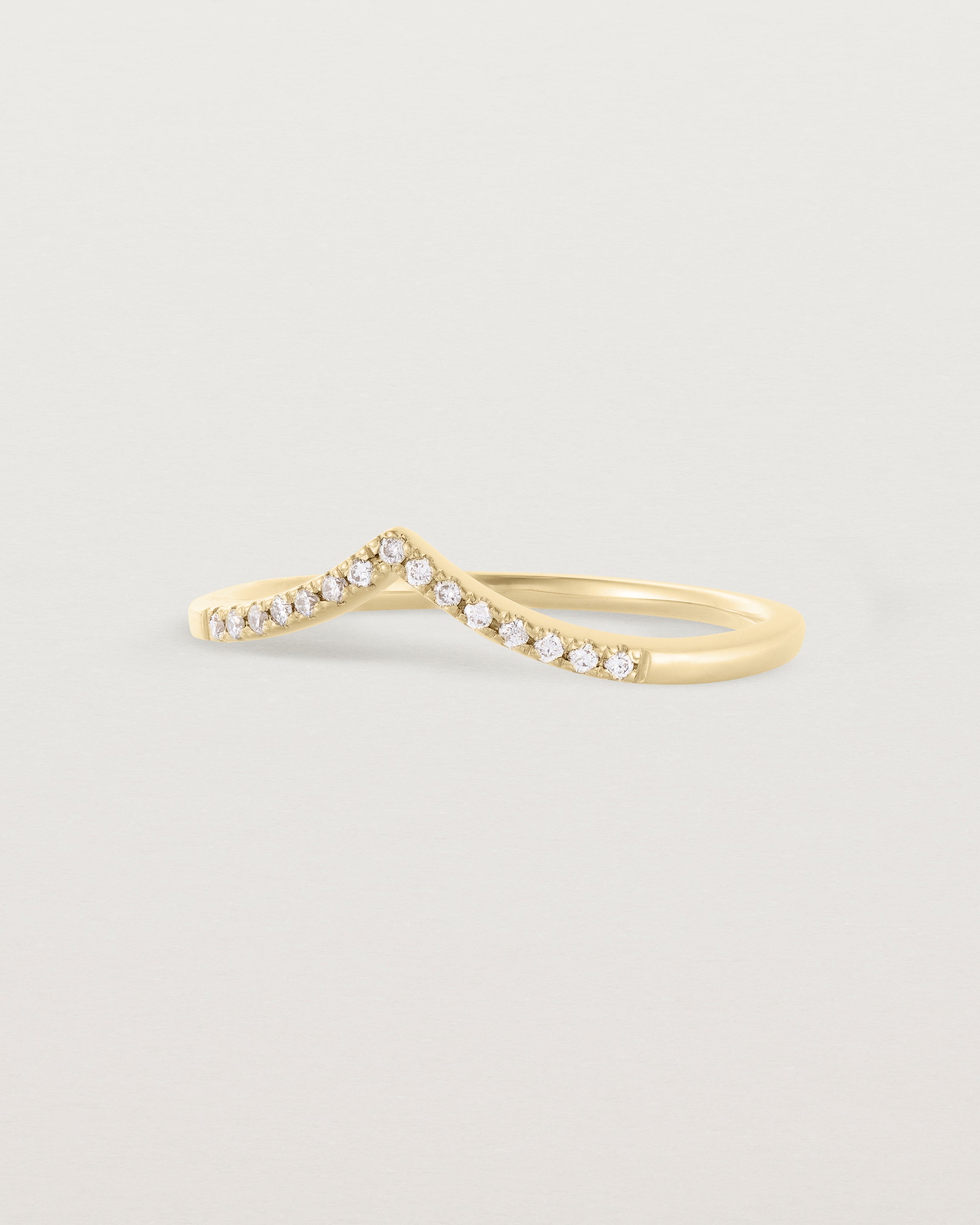 Side view of our white diamond gentle point ring in yellow gold