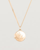 Close up view of the Golden Wattle Locket in rose gold.