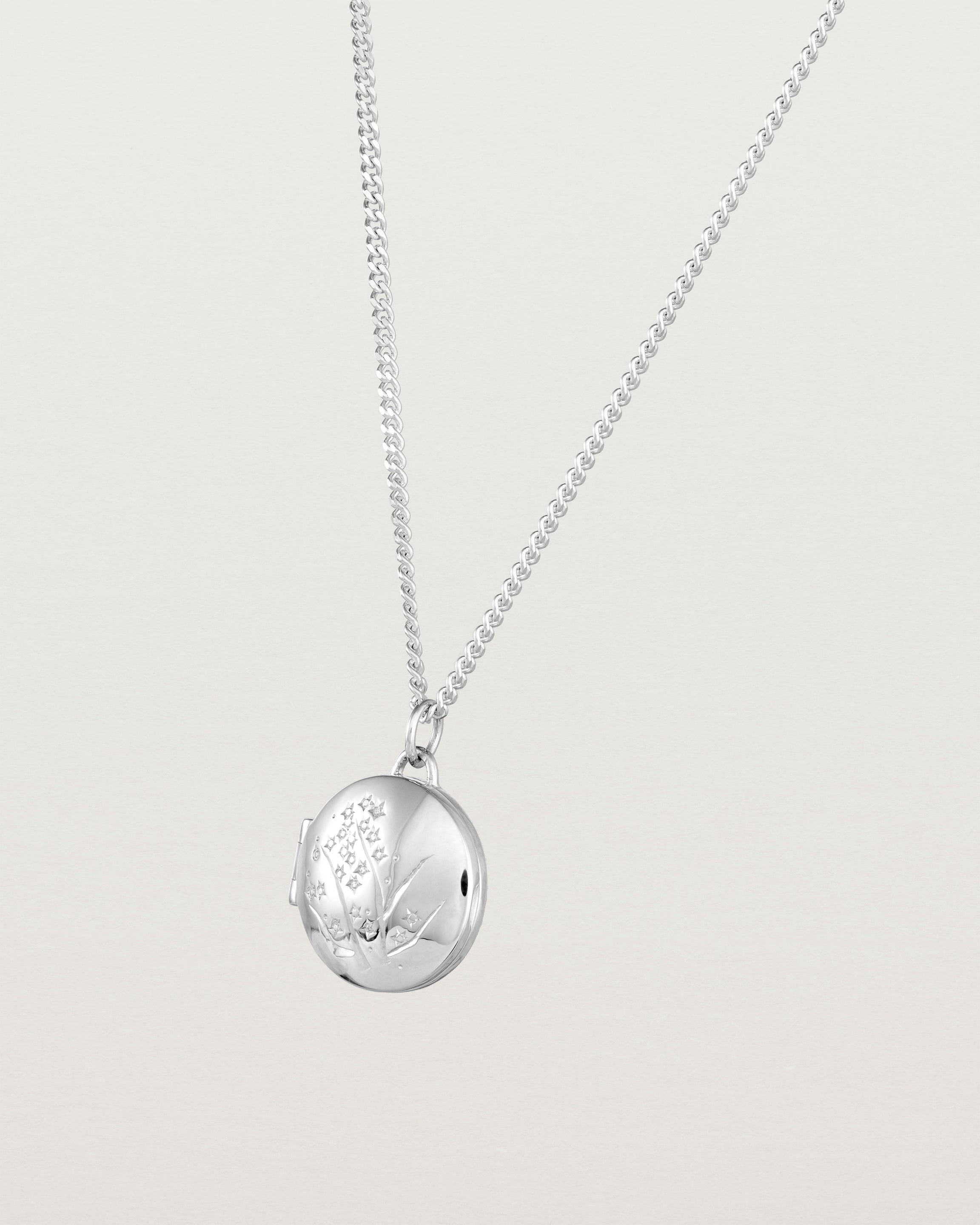 Angled view of the Golden Wattle Locket in sterling silver.